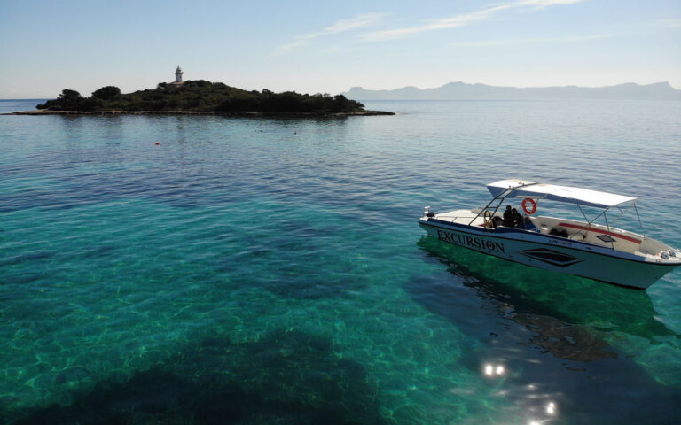 Speedboat on a private boat trip anchored off an islet in Alcudia, Mallorca