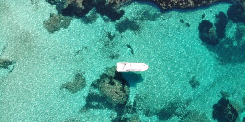 Aerial view of a private boat in crystal-clear waters in Mallorca