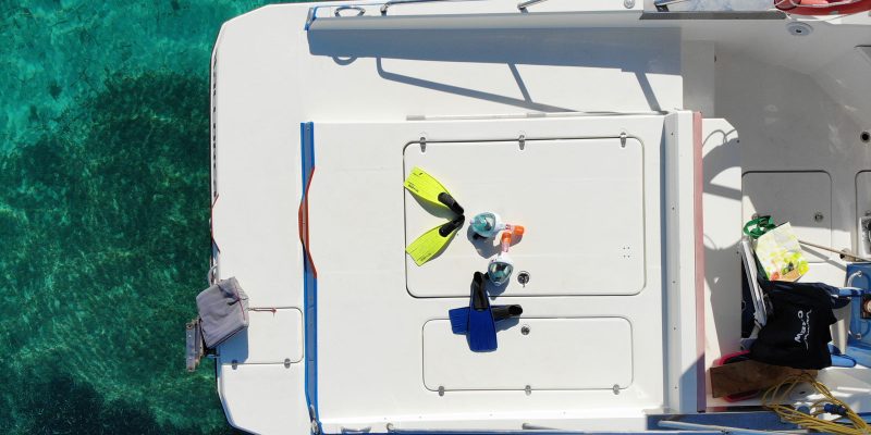 Snorkeling equipment on board a private boat in Mallorca above crystal-clear waters