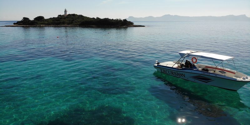 Speedboat on a private boat trip anchored off an islet in Alcudia, Mallorca